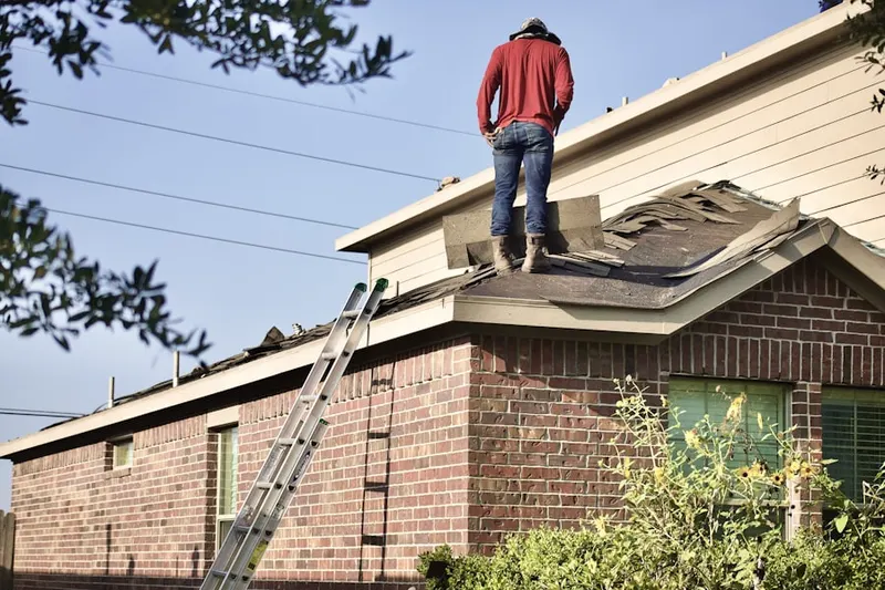 Professional roofer working on a residential roof in Jacobs Corner